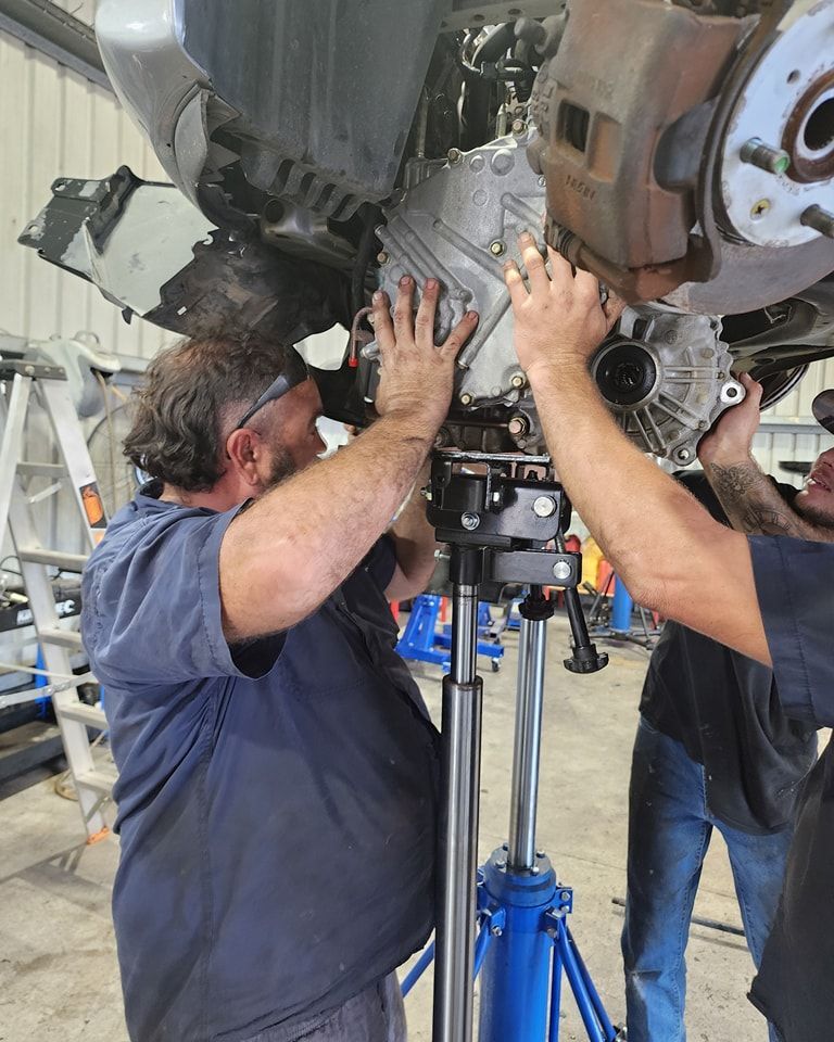 Two Men Are Working On A Car In A Garage — M8S Rates Mechanical In Gladstone Central, QLD