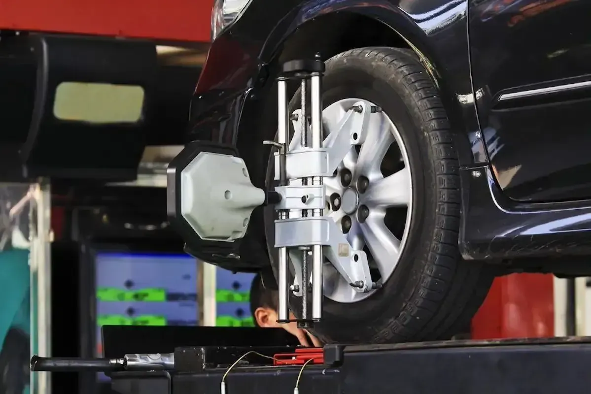 A Car Is Being Adjusted By A Machine In A Garage — M8S Rates Mechanical In Gladstone Central, QLD