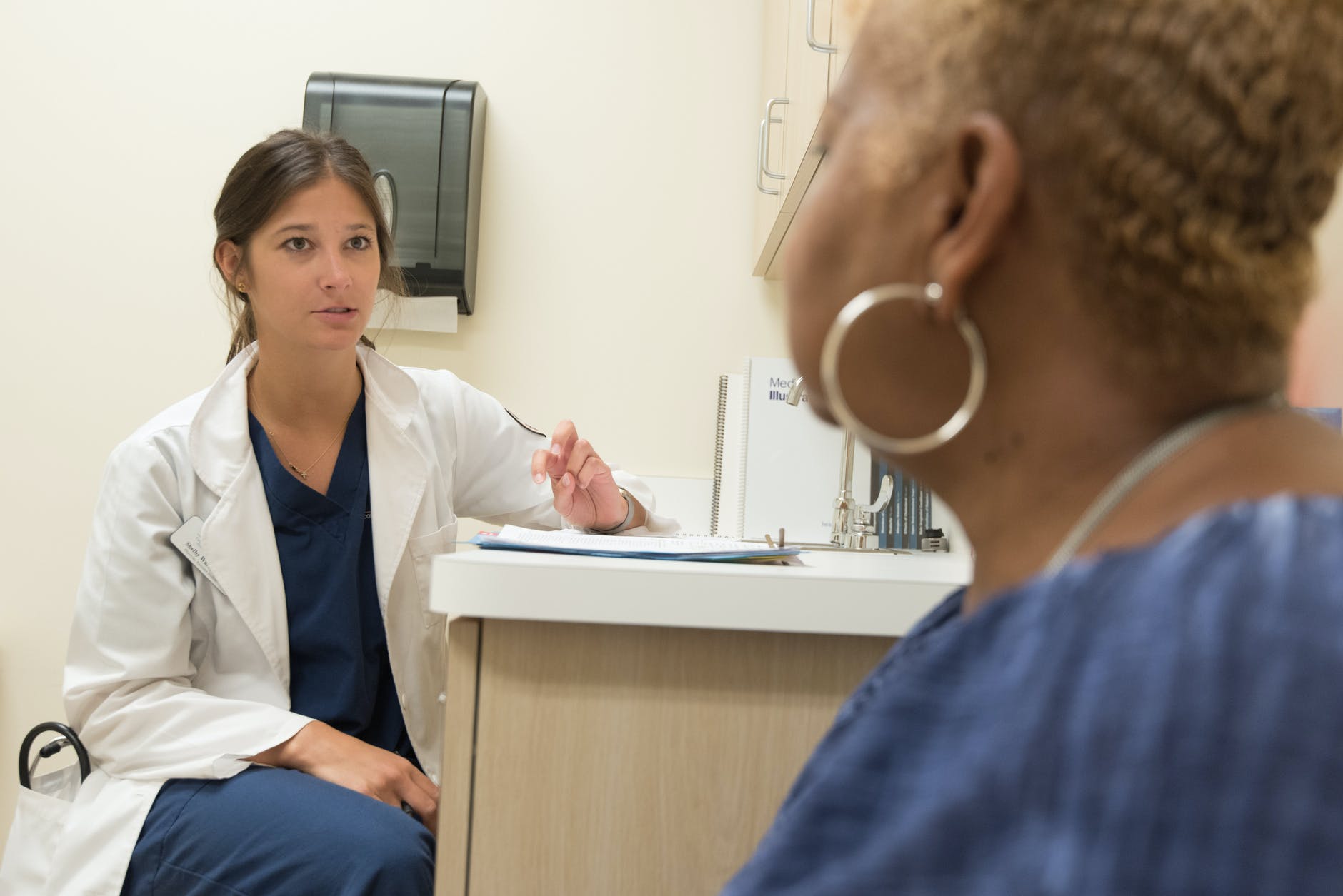 A doctor is talking to a patient in an office.