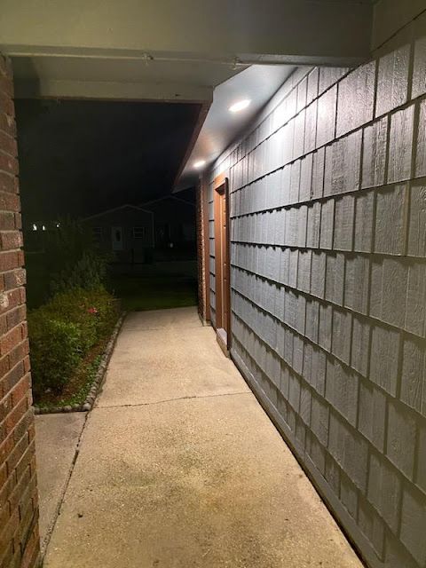 A walkway between two brick buildings at night A walkway between two brick buildings at night