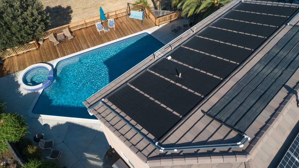 Aerial View of a House With a Pool, and a Roof Covered With Solar Panels — Tempshift Pool Heating in Gosford, NSW