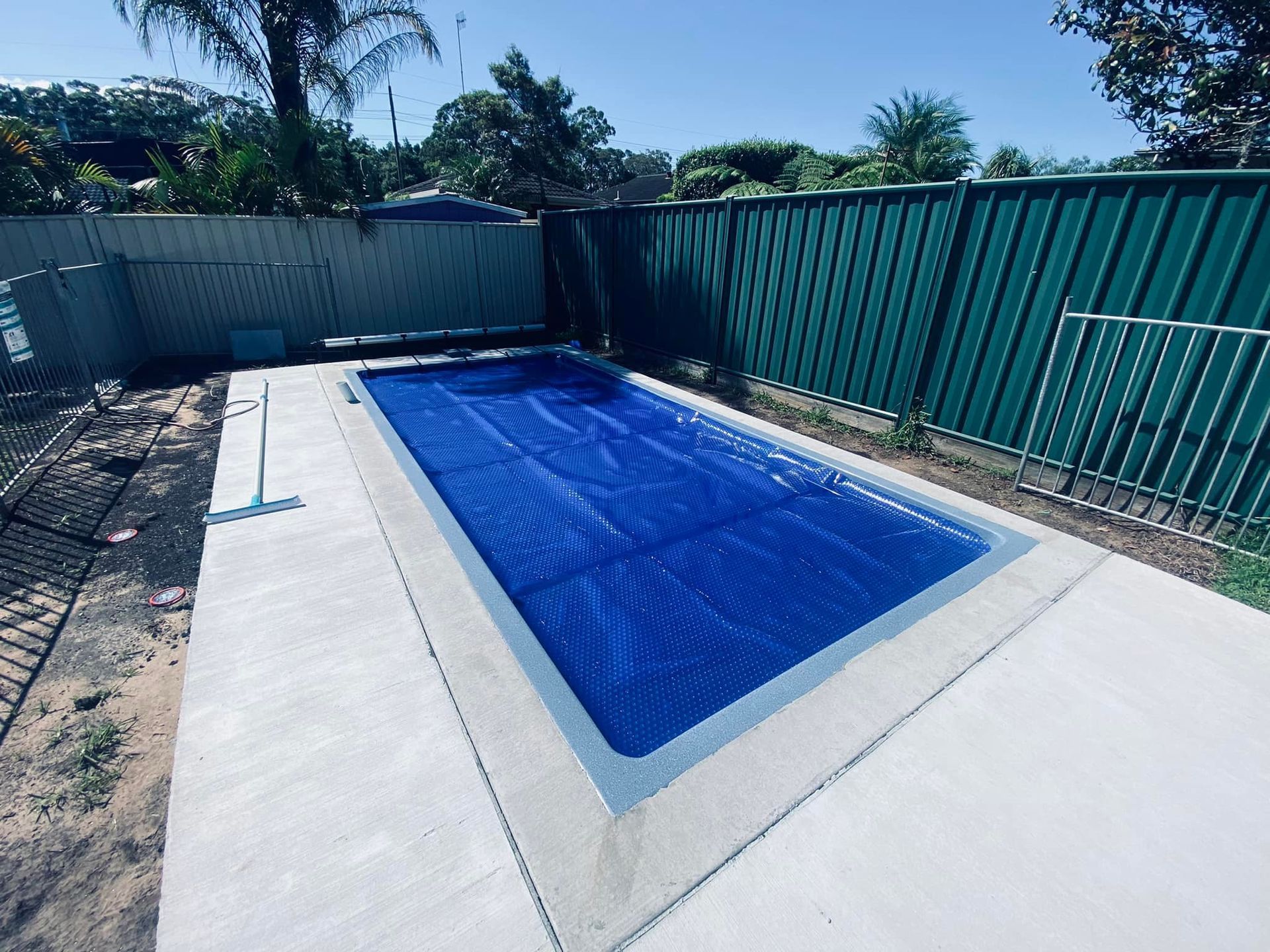 A Rectangular Swimming Pool With a Blue Cover — Tempshift Pool Heating in Buff Point, NSW