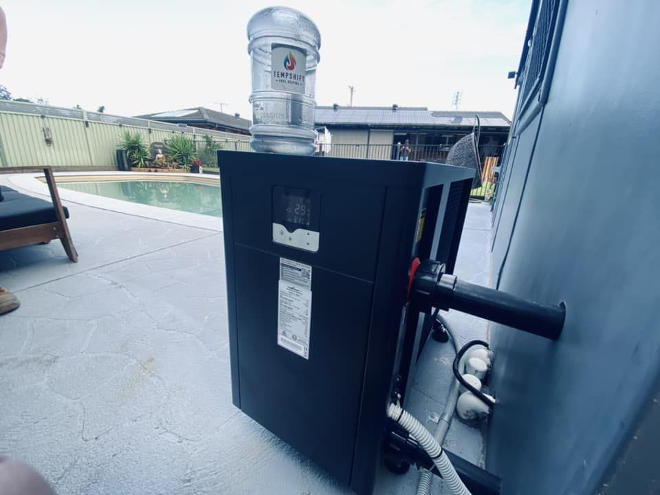 Black Pool Heater Near a Pool — Tempshift Pool Heating in Central Coast, NSW