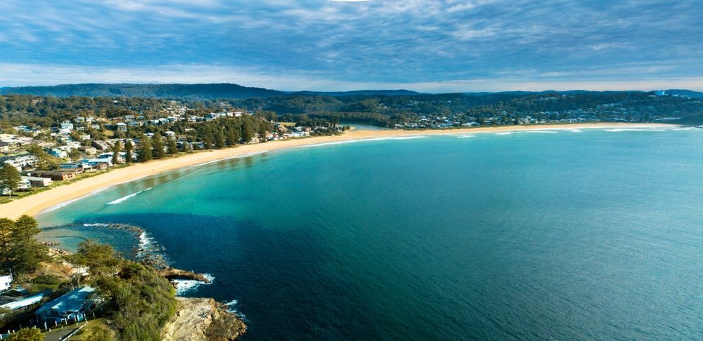 Aerial View of a Beach With Turquoise Water, a Sandy Shore, and a Town — Tempshift Pool Heating in Central Coast, NSW