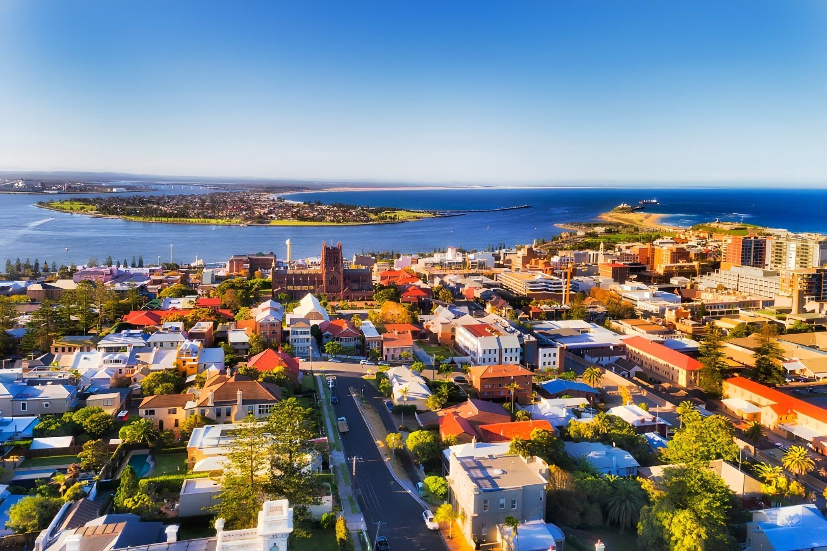 Aerial View of a Coastal City With Buildings, Ocean, and Blue Sky on a Sunny Day — Tempshift Pool Heating in Newcastle, NSW