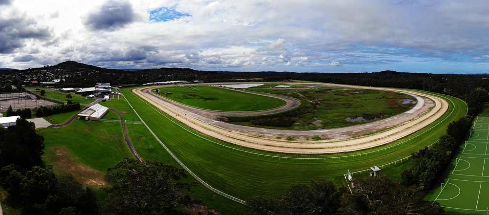 An Aerial View of a Racetrack With a Grassy Field and a Cloudy Sky — Tempshift Pool Heating in Wyong, NSW