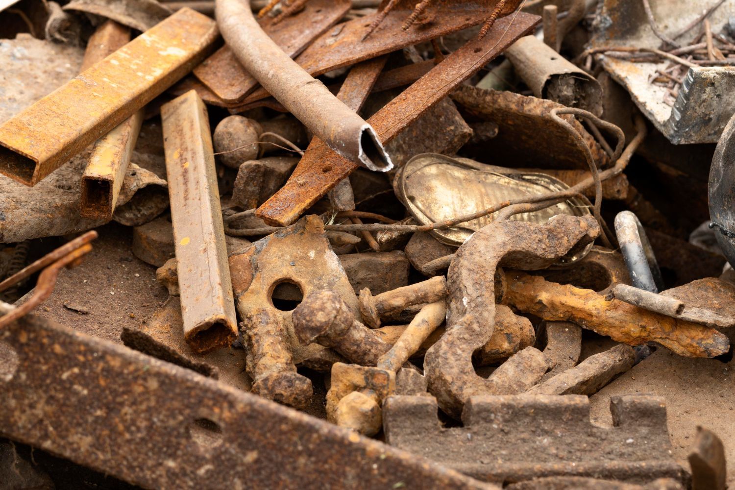 A pile of rusty metal is sitting on the ground.
