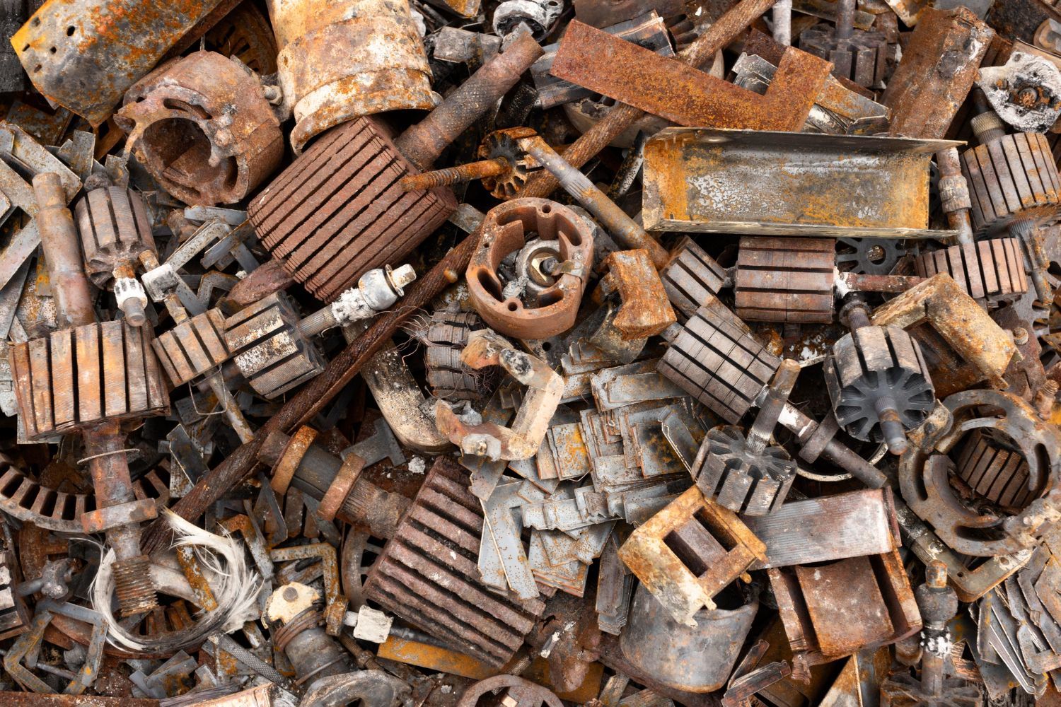 A pile of rusty metal scraps sitting on top of each other.
