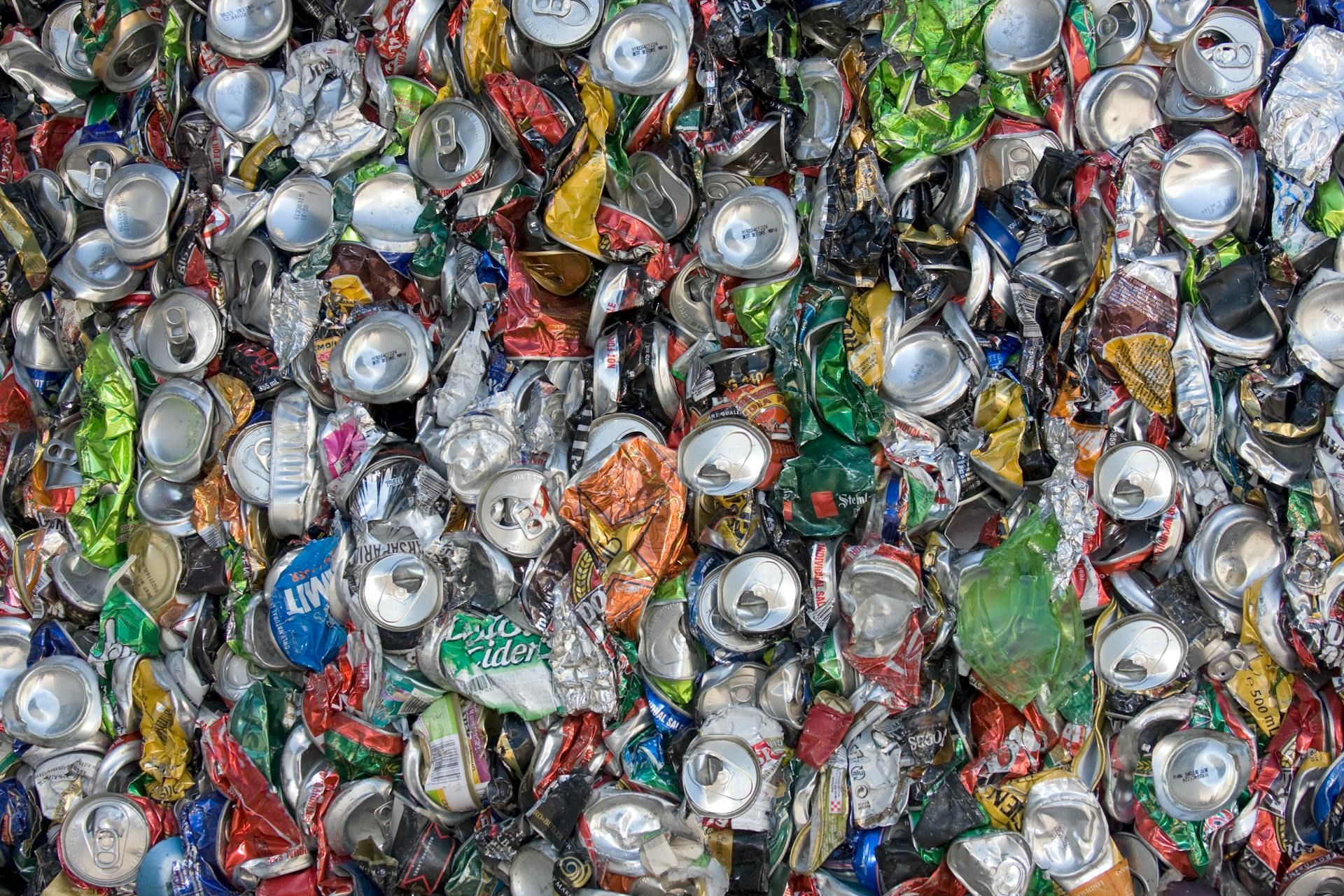 A pile of crushed aluminum cans sitting on top of each other.