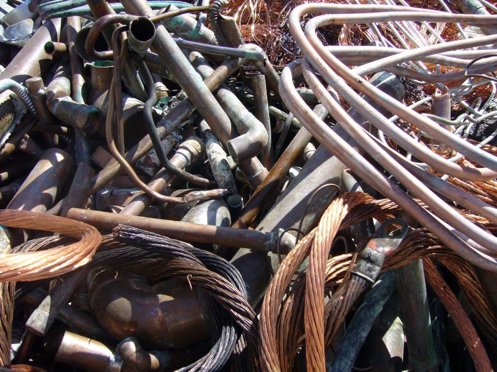 A pile of scrap metal including copper wires and pipes.