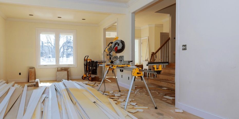 Kitchen renovation with saws and lumber in a bright room