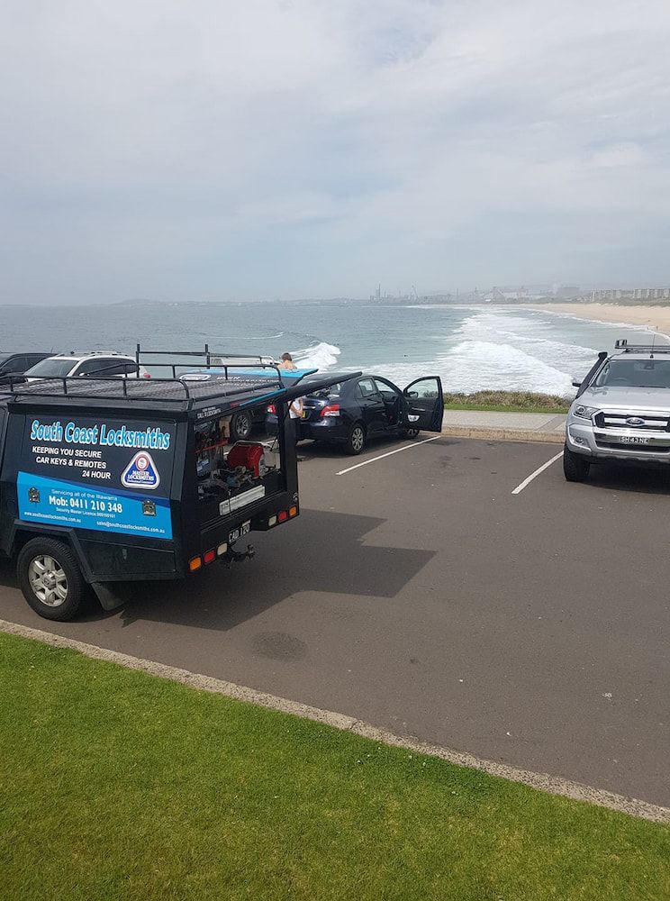 A Truck is Parked on the Side of the Road Next to a Beach — South Coast Locksmiths in Thirroul, NSW