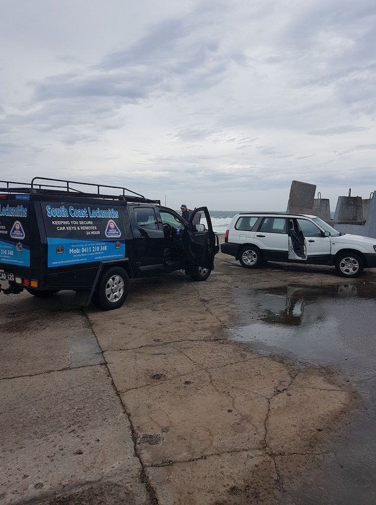 Two Trucks Are Parked Next to Each Other in a Parking Lot — South Coast Locksmiths in Corrimal, NSW