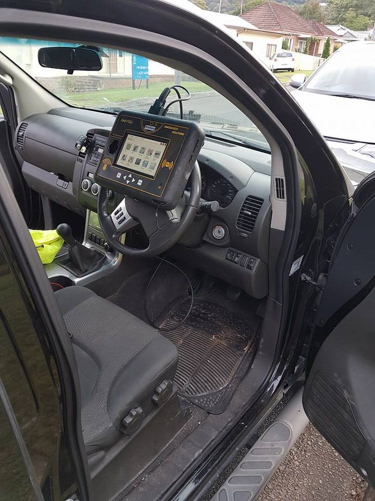 The Inside of a Car With the Door Open and a Tablet on the Dashboard — South Coast Locksmiths in Helensburgh, NSW