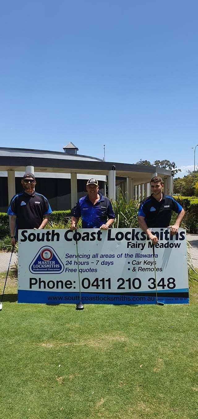 Three Men Holding a Sign on a Meadow— South Coast Locksmiths in Fairy Meadow, NSW