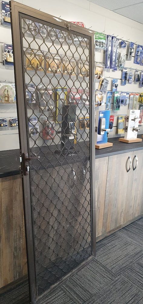 A Metal Gate is Sitting in a Store Next to a Counter — South Coast Locksmiths in Fairy Meadow, NSW