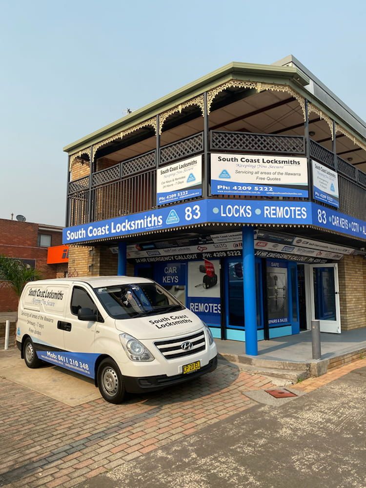A White Van is Parked in Front of a Building — South Coast Locksmiths in Austinmer, NSW