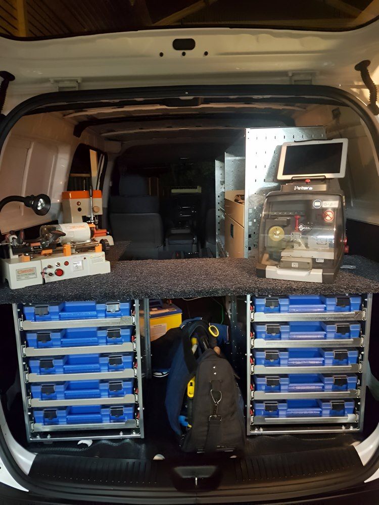 The Back of a Van With a Bunch of Blue Drawers and a Monitor — South Coast Locksmiths in Shellharbour, NSW