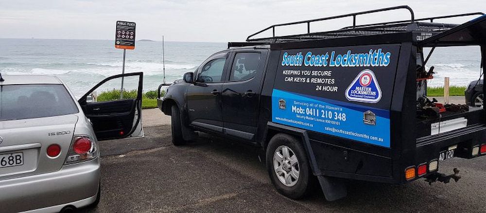 A Black Truck is Parked Next to a Silver Car in a Parking Lot — South Coast Locksmiths in Fairy Meadow, NSW
