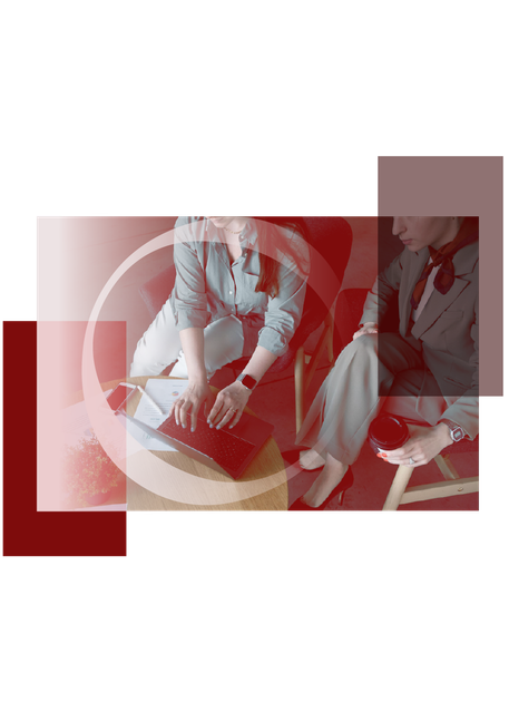 Two women seated at a table in a red-tinted collage-style office scene