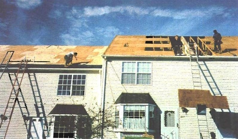 Roof work on multifamily residential building