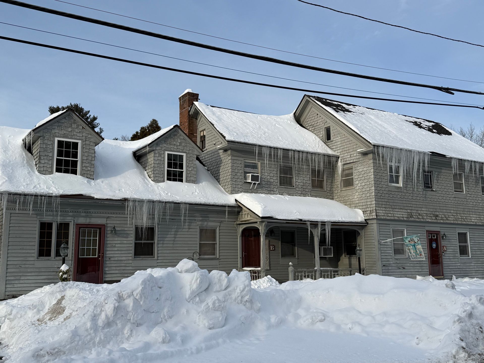 Multifamily residential building with snow and ice on roof