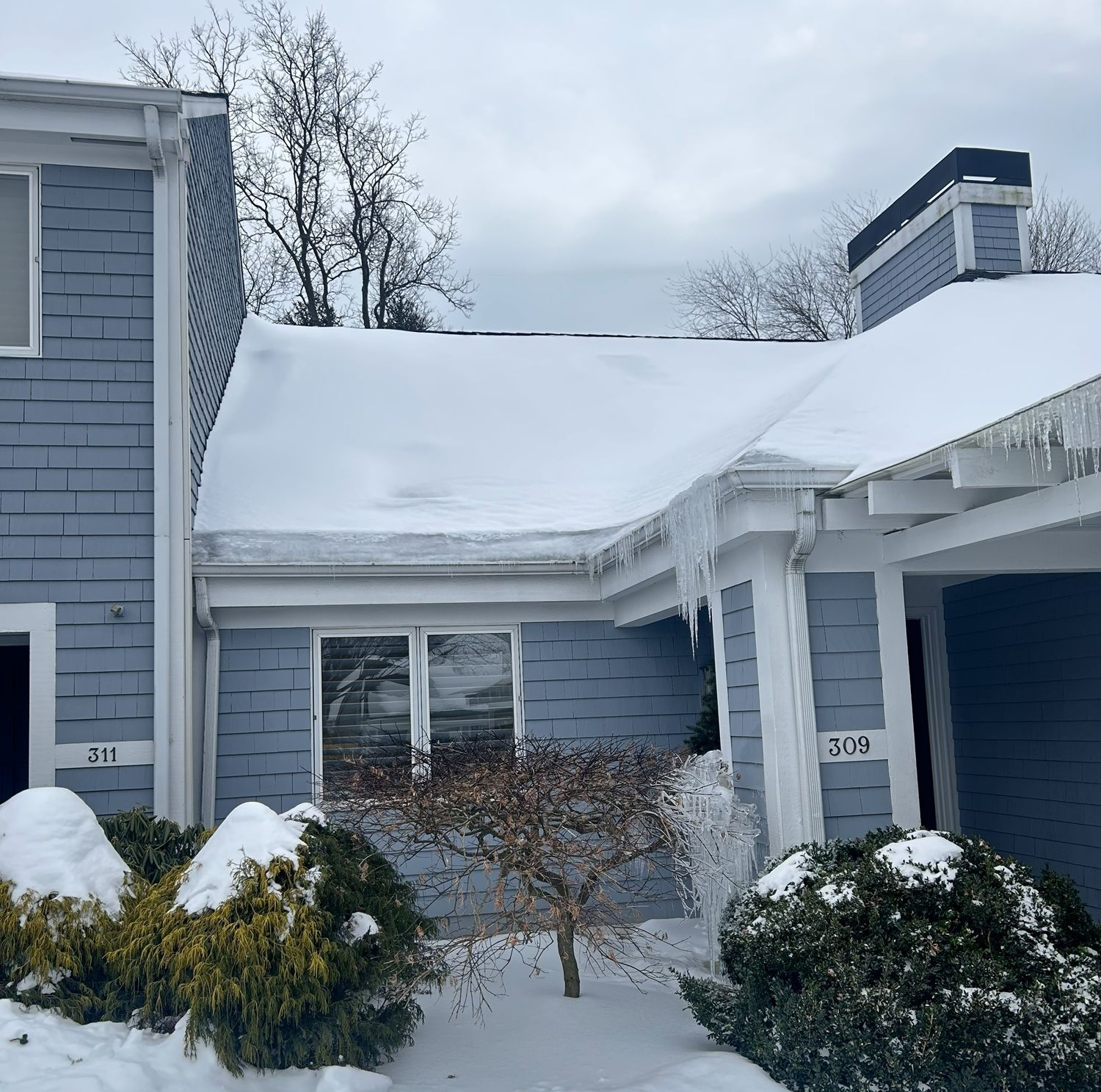 Residential unit with snow and ice on roof