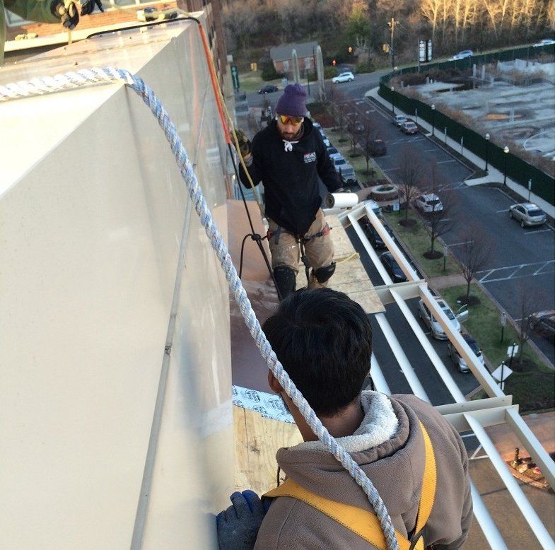 men working on the outside of a building
