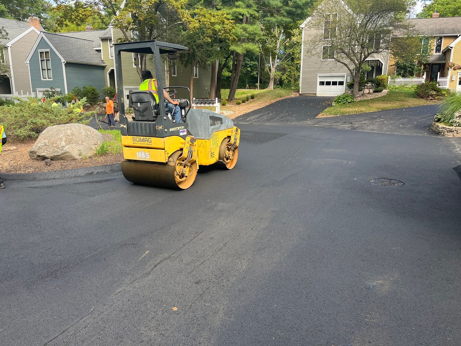 Machine paving roadway