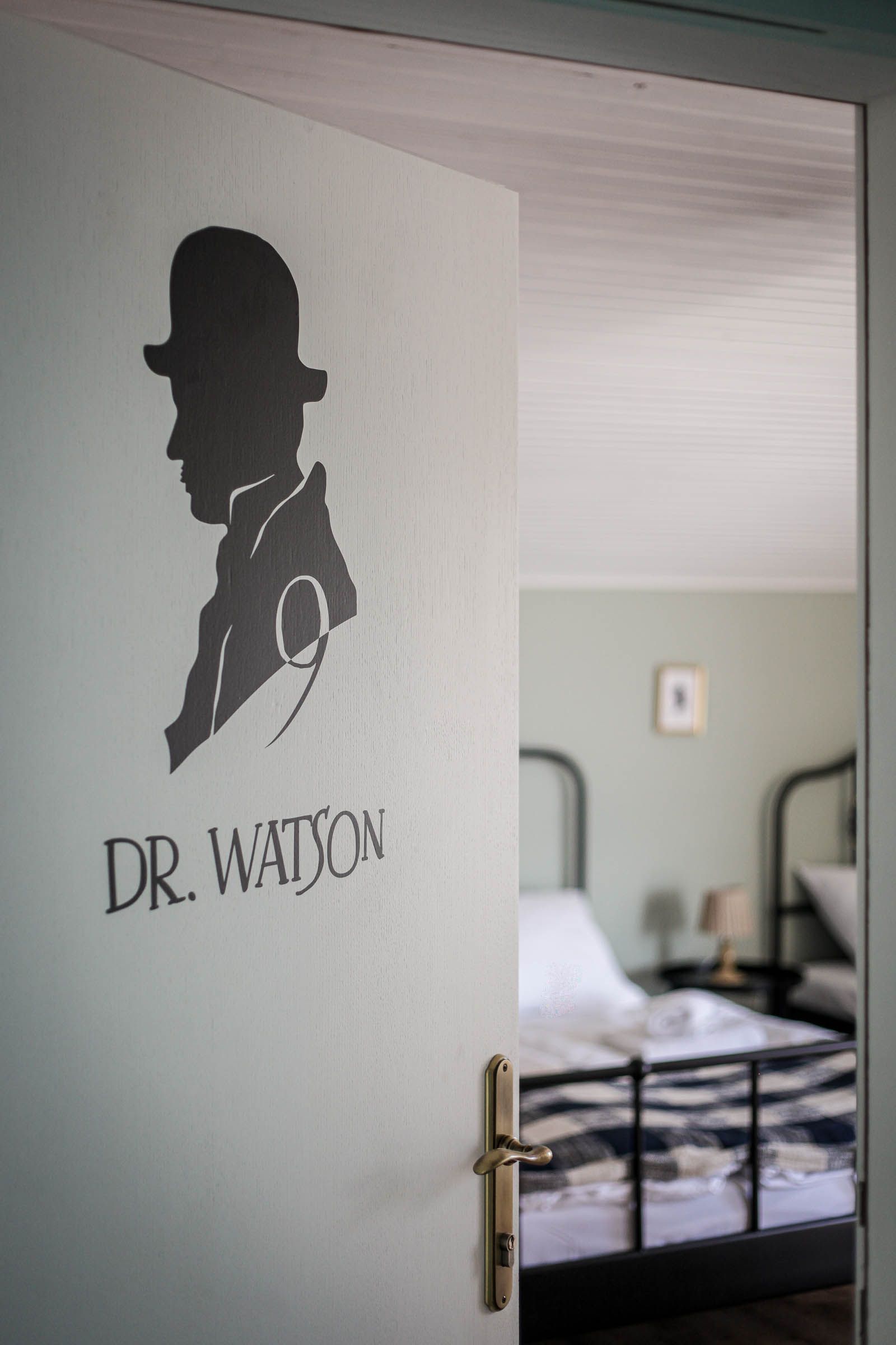 Hospital room doorway with Dr. Watson sign and a visible bed inside