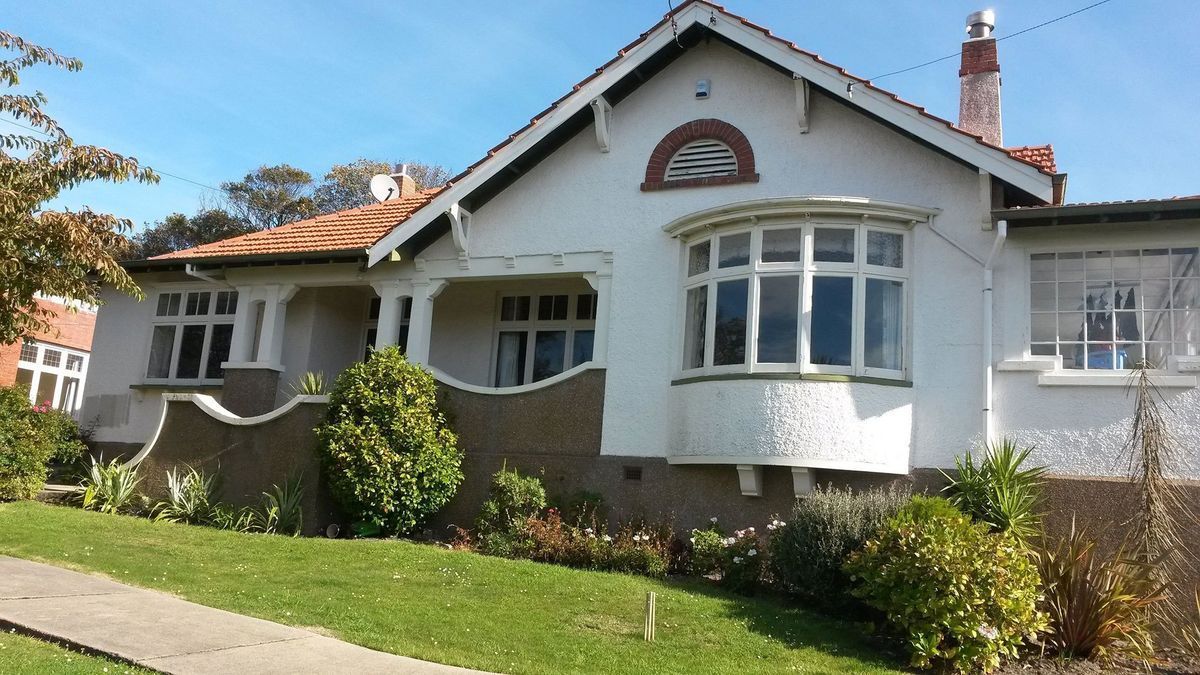 A small white house with a lot of windows
