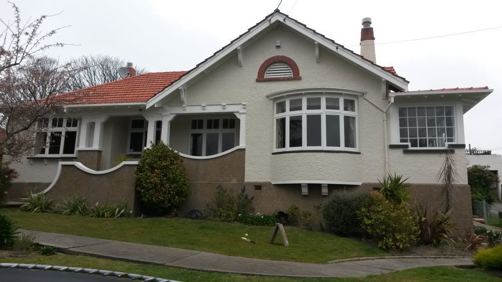 A large white house with a red roof