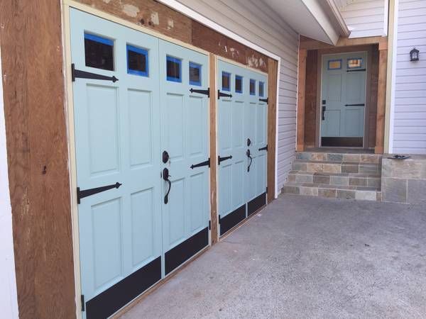 A row of light blue garage doors with black handles