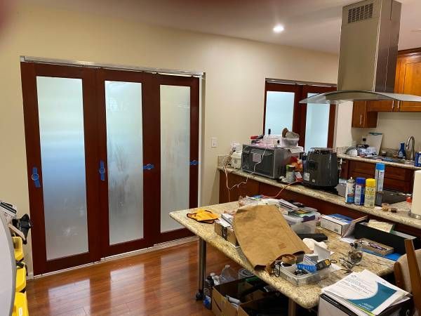 A kitchen with a table and sliding glass doors.