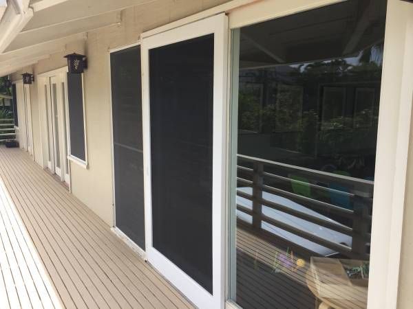 A house with sliding glass doors and a balcony