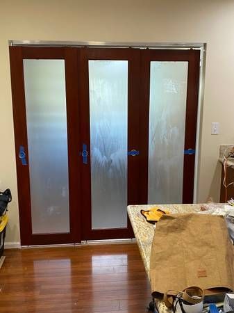 A room with sliding glass doors and a table.