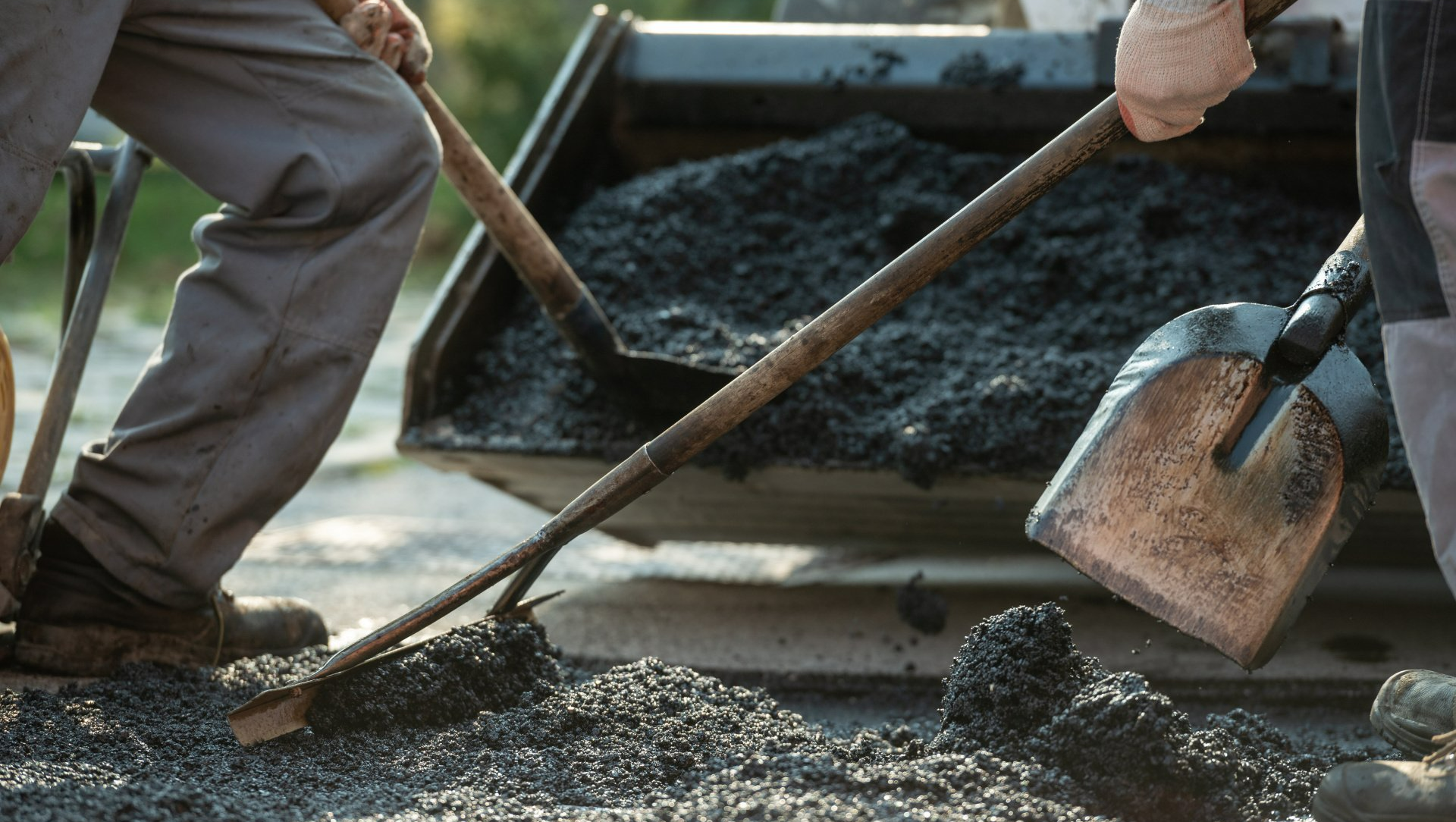 workers spreading asphalt hot mix in columbus