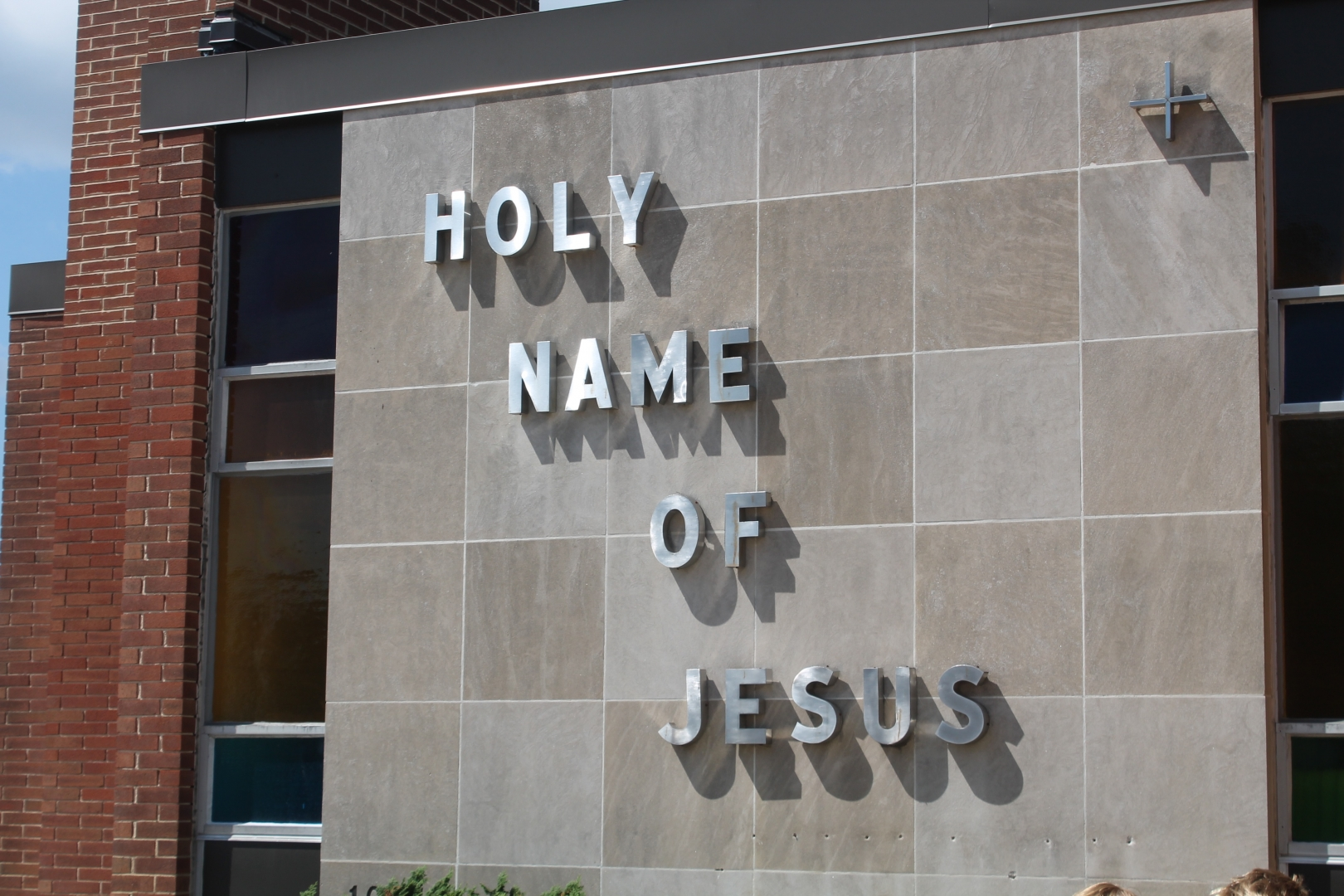 A sign that says holy name of jesus on it