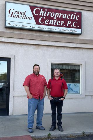 A group of people standing in front of a chiropractic center.