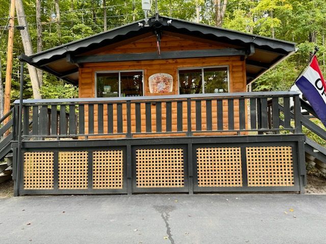 A small house with a balcony and a flag that says ok on it