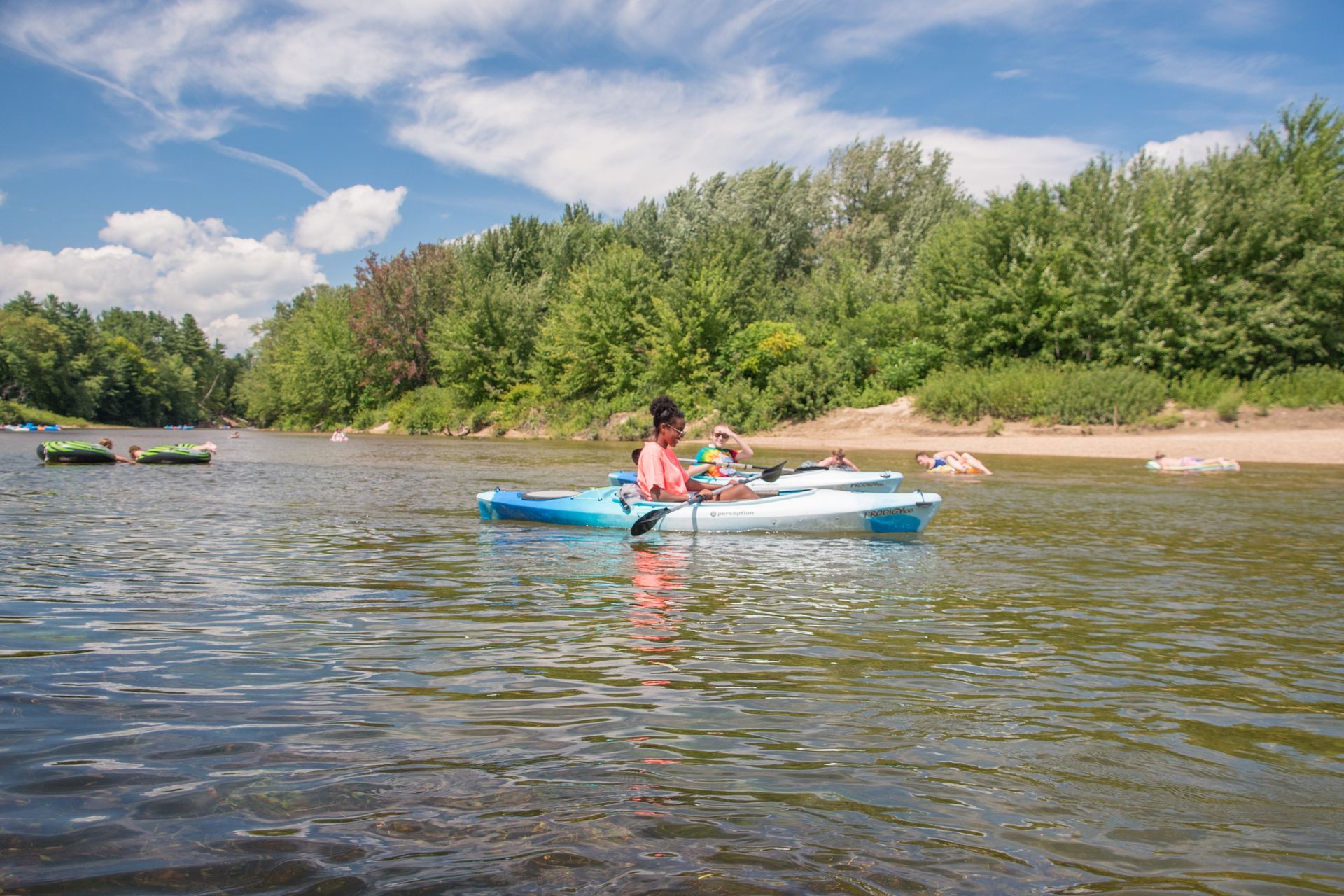 A person is riding a kayak on a river.