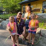 A family is posing for a picture with medals around their necks.