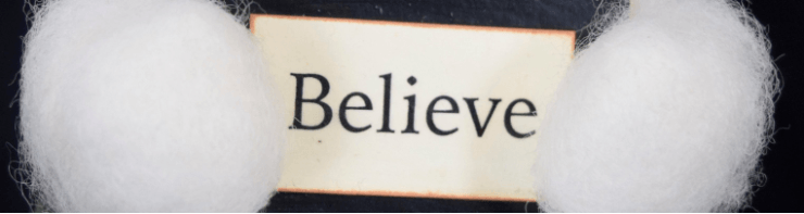 The word believe is written on a piece of paper