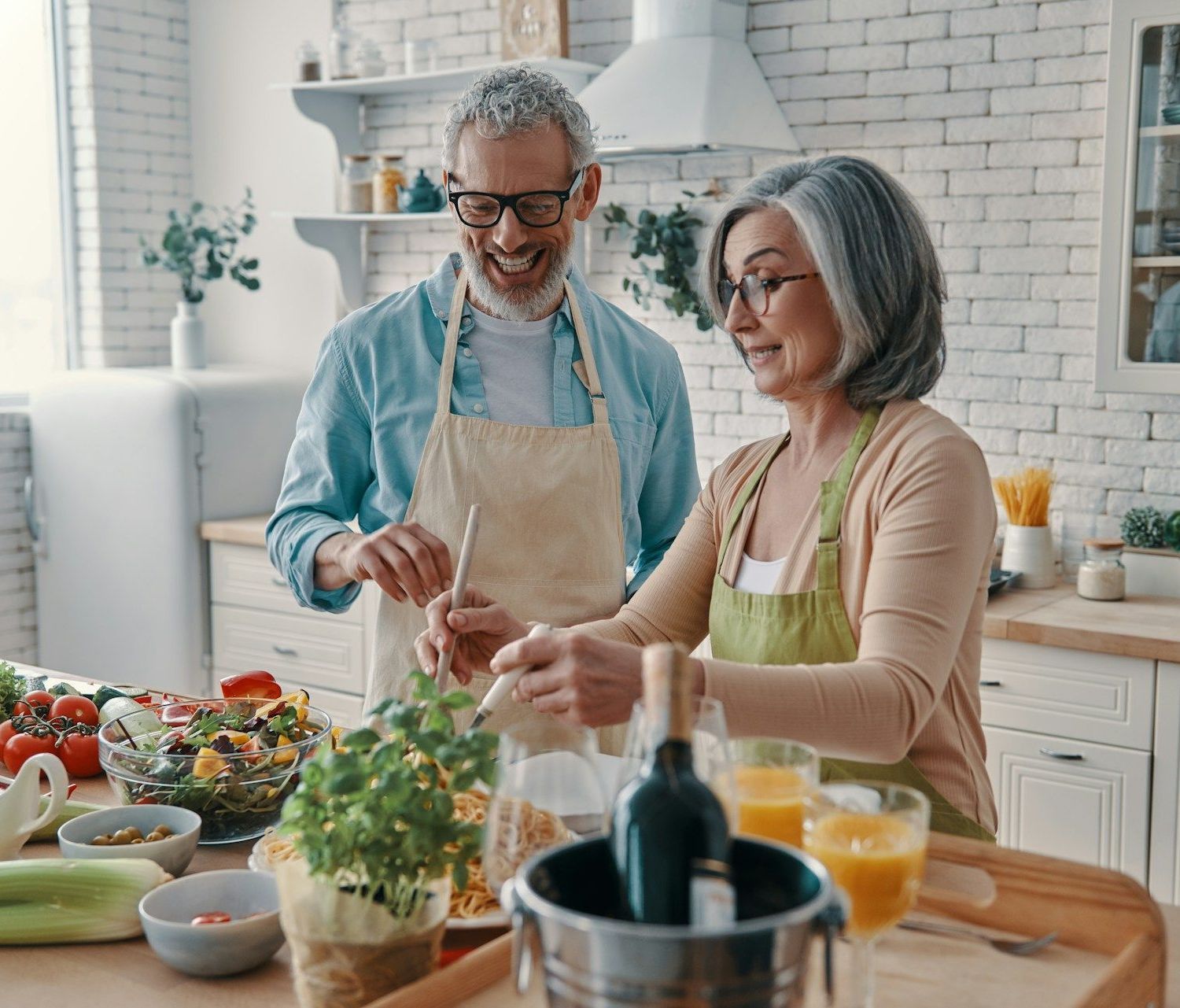 A man and a woman are preparing food in a kitchen.