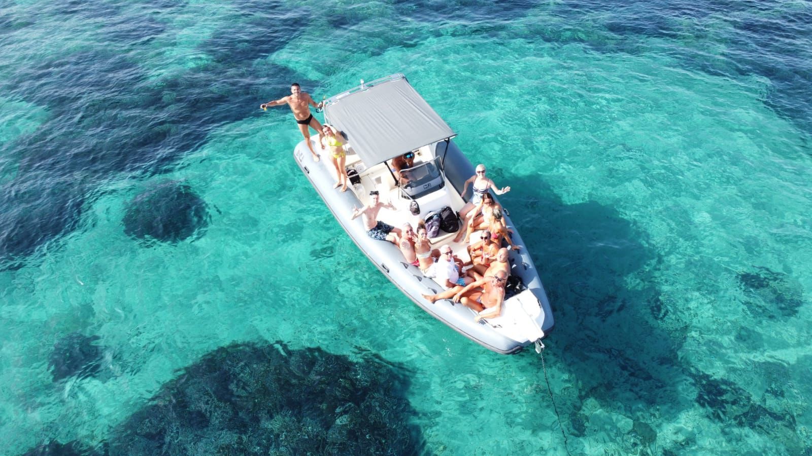 People on a boat, toasting with champagne glasses.