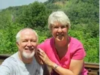 A man and a woman are posing for a picture together.