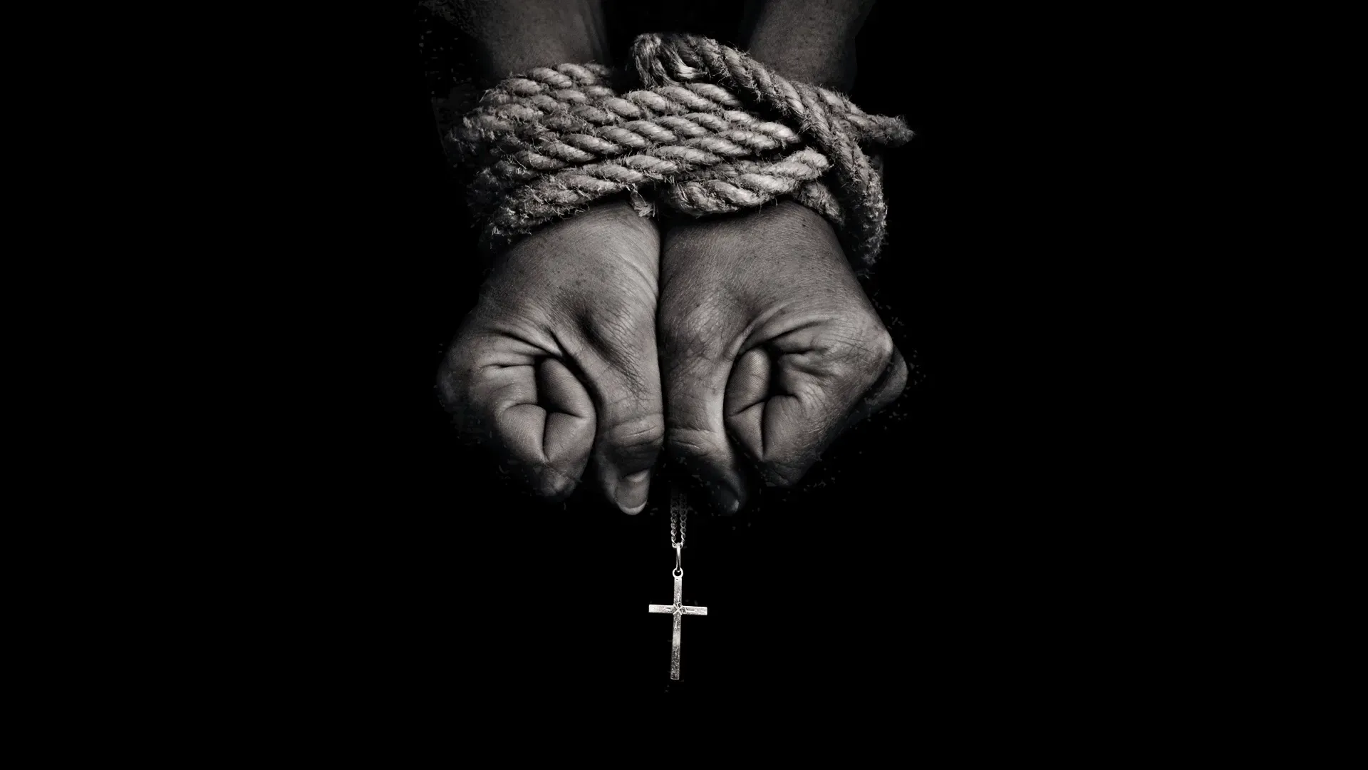 Persecuted Church photo with hands bound by rope holding a cross necklace