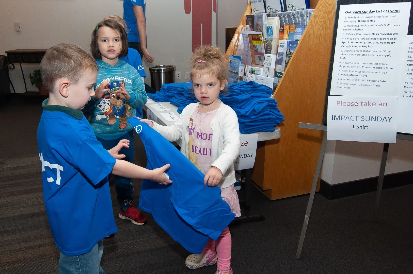 A boy in a blue shirt with the letter t on it