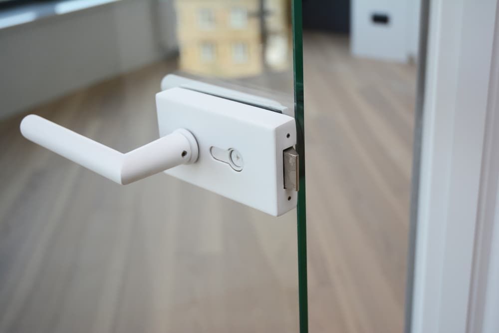 A Close Up Of A White Door Handle On A Glass Door — Northern Glazing Glass & Aluminium In Smithfield, QLD