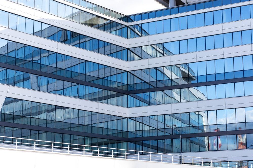 A Large Building With A Lot Of Windows And A Bridge In Front Of It — Northern Glazing Glass & Aluminium In Smithfield, QLD